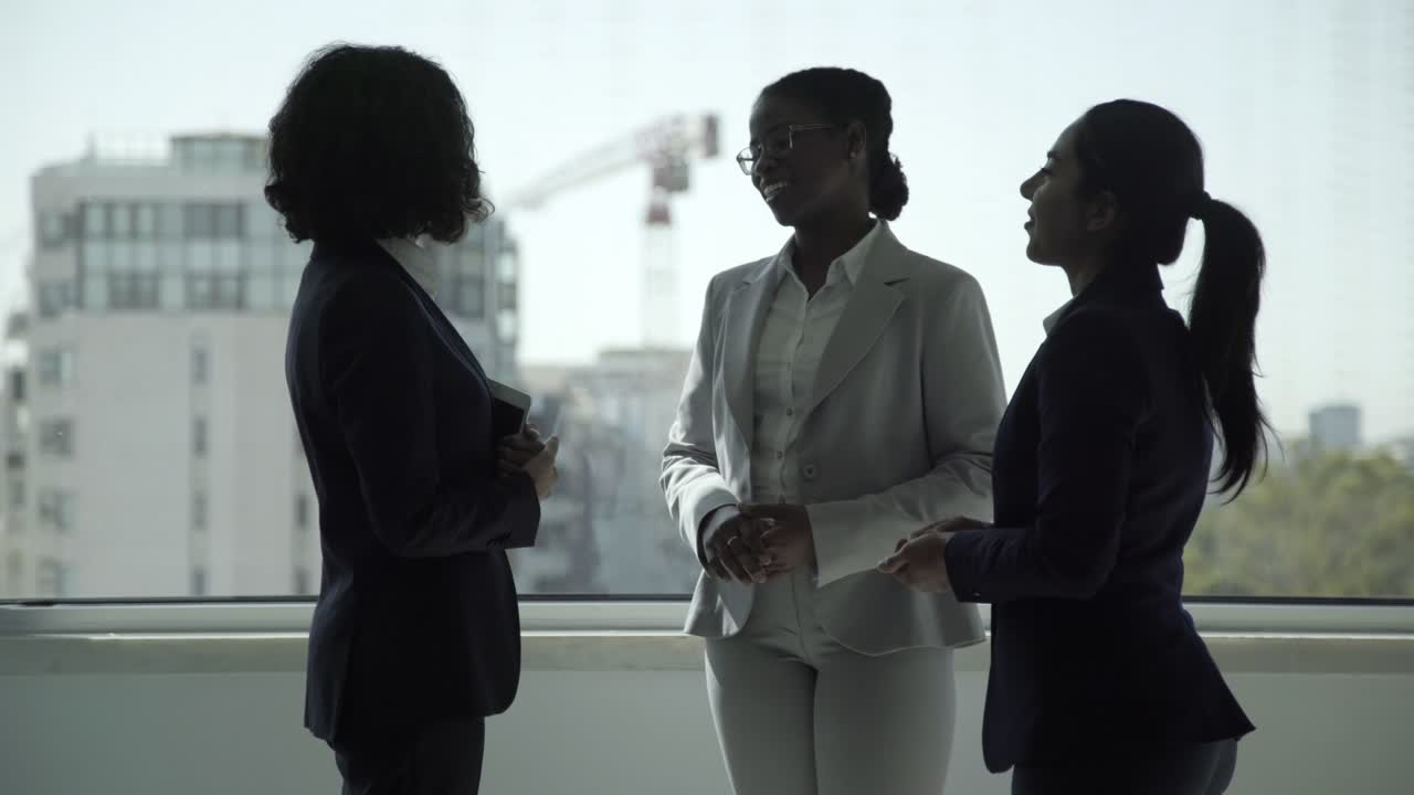 Cheerful businesswomen talking in office