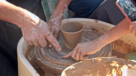 potter working with apprentice
