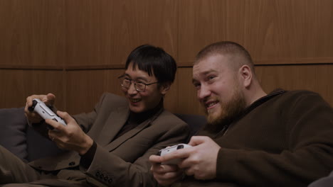 two friends enjoying a gaming session on a couch