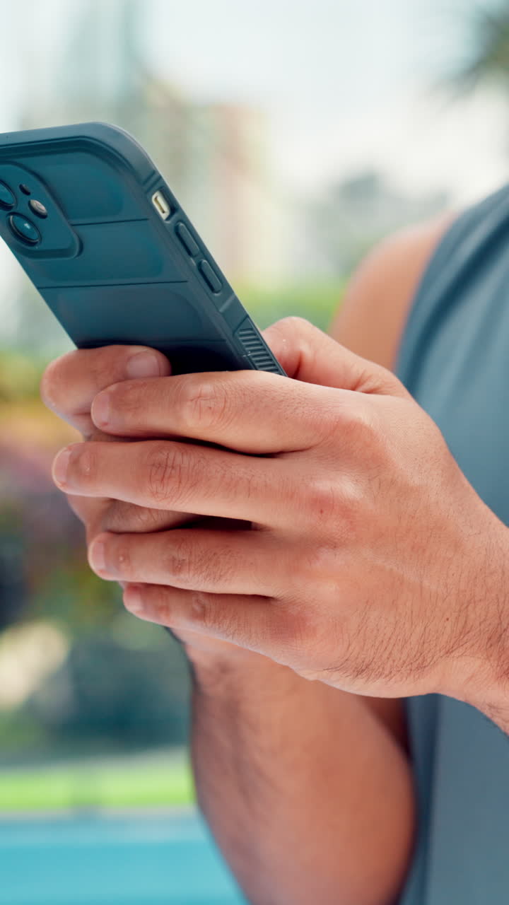 Close-up of Person's Hands Using a Smartphone Outdoors