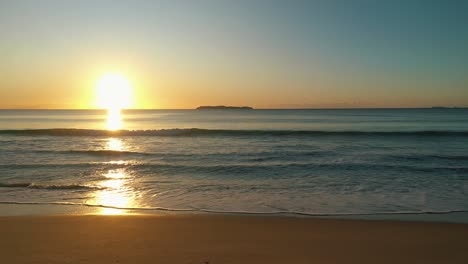 beach sunrise shining golden foamy waves rolling towards sand beach sunlight