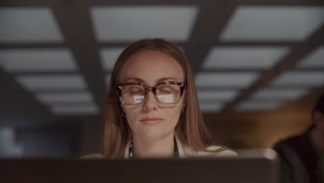 businesswoman focusing on laptop at workplace in office