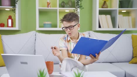 Little-boy-working-on-his-father's-laptop-and-file.-He-dreams-of-becoming-a-businessman.