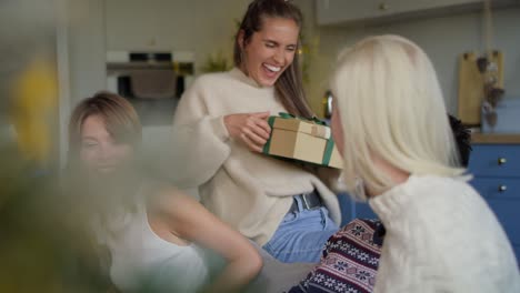 Woman-receiving-sweater-as-Christmas-present