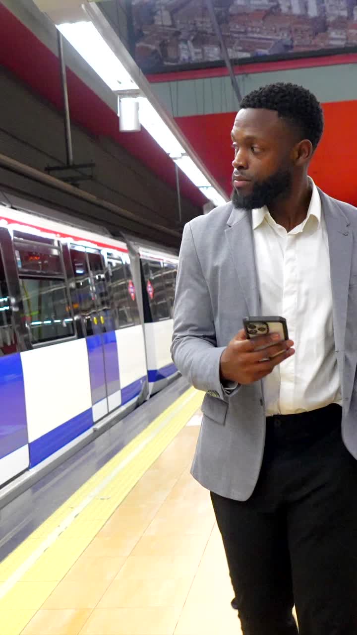 Man using phone on subway platform
