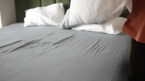 person making a bed
