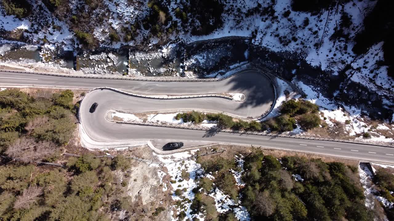 Curvy alpine road with car passing