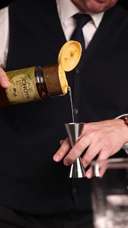 bartender preparing a cocktail with choya