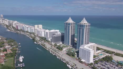 a mesmerizing aerial view of contemporary hotel structures lining the ocean, presenting an impressive spectacle of architecture and water vistas