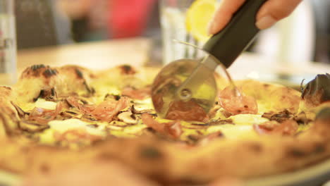 slicing pizza with a specialized pizza cutter