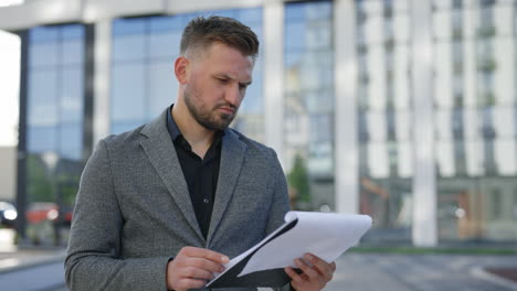 businessman reviewing documents outdoors
