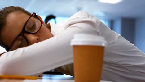 Tired-graphic-designer-sleeping-on-his-desk-