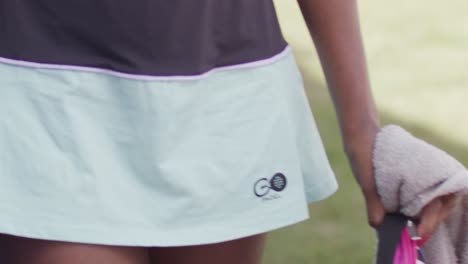 close-up shot of a padel outfit of a girl with towel in hand