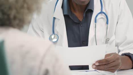 Mid-Section-Male-Doctor-Discussing-Results-With-Patient