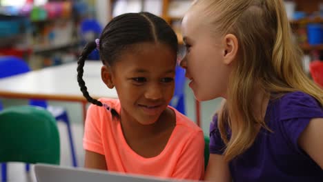 Front-view-of-Mixed-race-schoolgirls-studying-on-laptop-in-the-classroom-4k