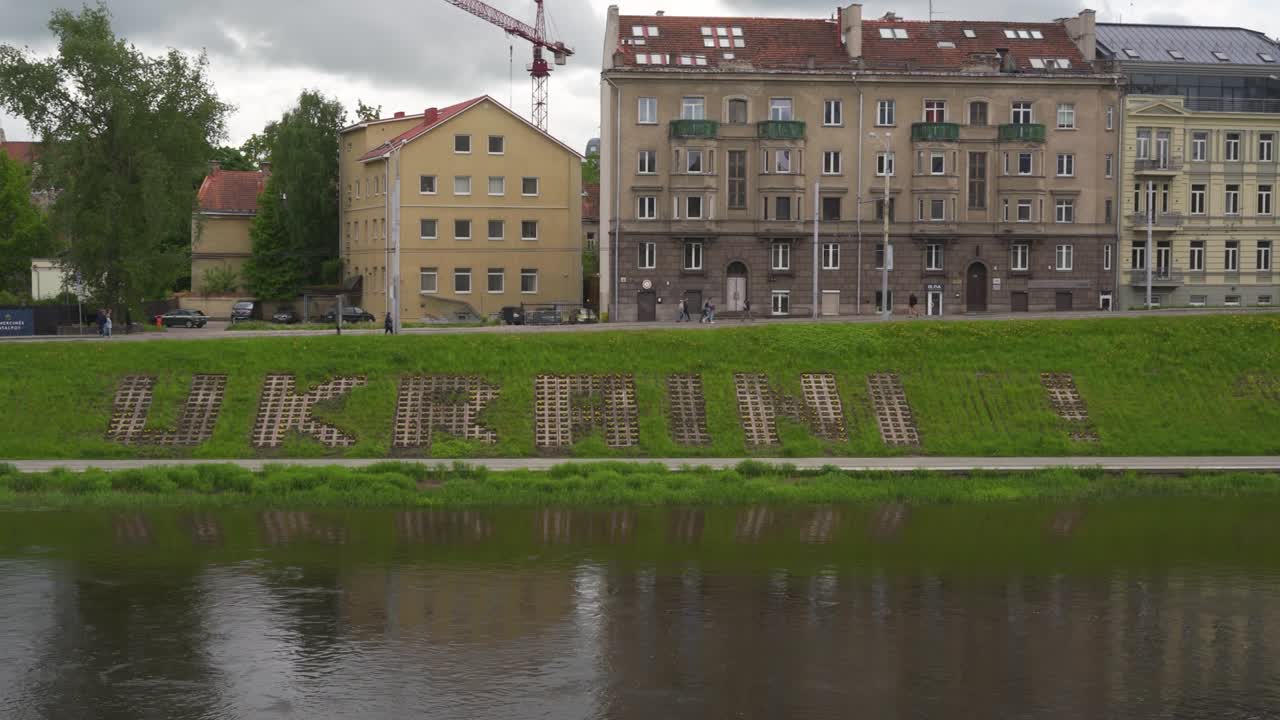 Vilnius, Lithuania – 29 May 2022. Glory to Ukraine sign on the riverside