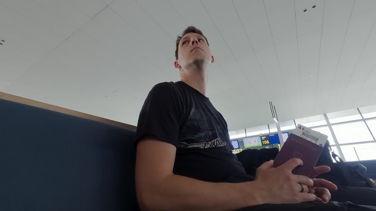 Traveler Holding Passport, Waiting At Departure Airport Terminal Before Flight