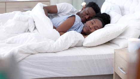 Kiss,-bed-and-couple-sleeping-together-in-bedroom