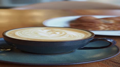 latte art and pastry in a cozy cafe