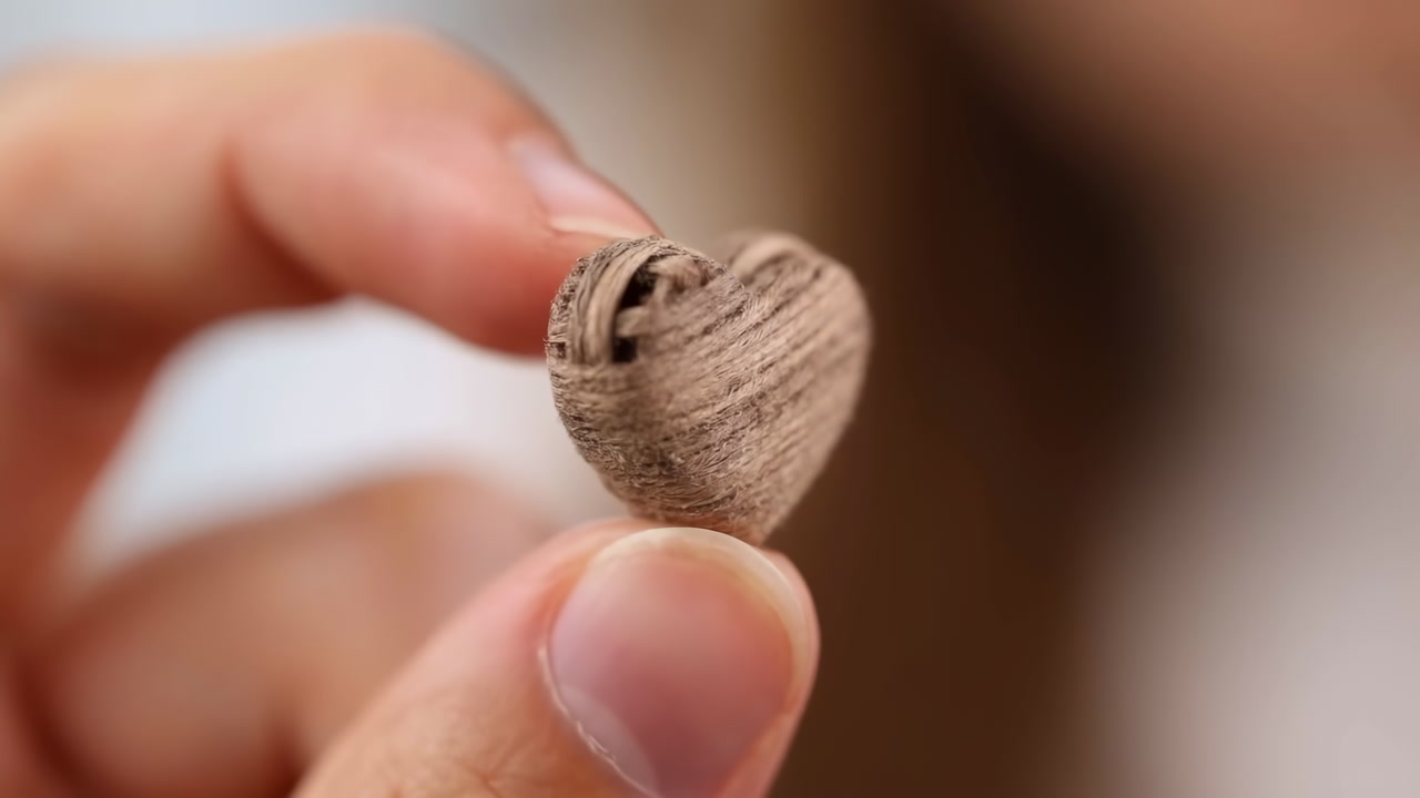 Closeup Hand Holding Wooden Heart, Blurred Background, Warm Tones, Visible Wood Grain, Delicate Tiny Token