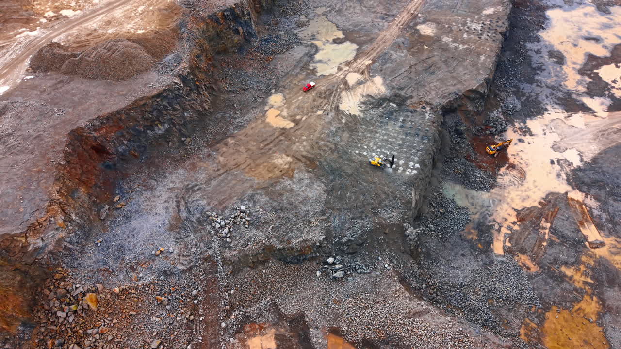 Excavation site with machinery. Heavy machinery is digging and moving earth at a large excavation site during daylight hours in a remote area