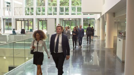 businesspeople in busy lobby area of modern office shot on r3d