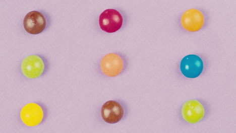 colorful round candies on purple background