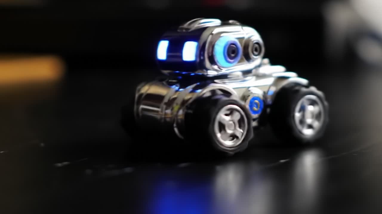 Shiny Robot Car with Blue Lights Displaying Advanced Design and Playful Features on a Black Surface Capturing Attention and Spark Imagination
