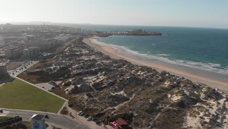 aerial view of the beach with surfers in west coast of portugal in baleal, peniche