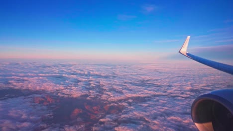 airplane window view travelling above the clouds