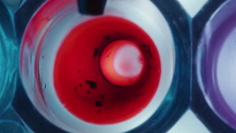 pipette pouring blood into colorless liquid during chemical experiment