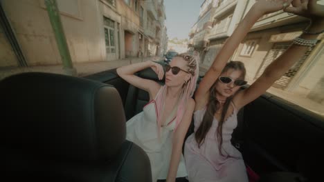 two women enjoying a road trip in a convertible