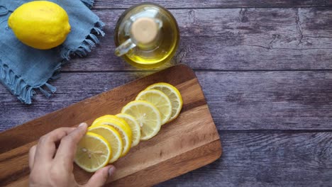 sliced lemons on a wooden cutting board