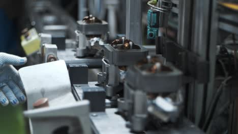 industrial worker pushing buttons at assembling line at manufacturing factory