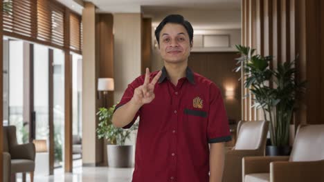 Happy-Indian-house-keeper-showing-victory-sign