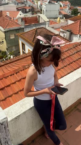 girl on rooftop with smartphone