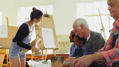 Woman-assisting-artists-in-pottery-4k