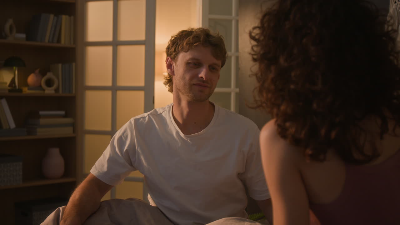 Couple in bed talking intimately