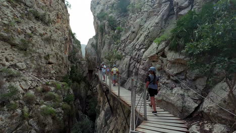 woman walking on wooden path deck observation towers in tarifa spain