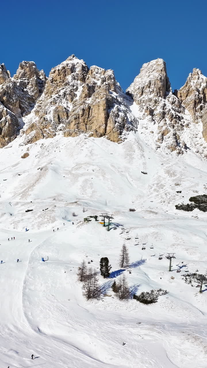 Aerial drone view of the Gardena Pass high mountain pass in the Dolomites, Italy. Vertical