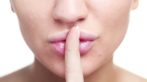 woman with finger on lips