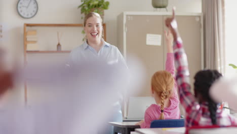 in school, students raising hands to answer teacher's question in classroom