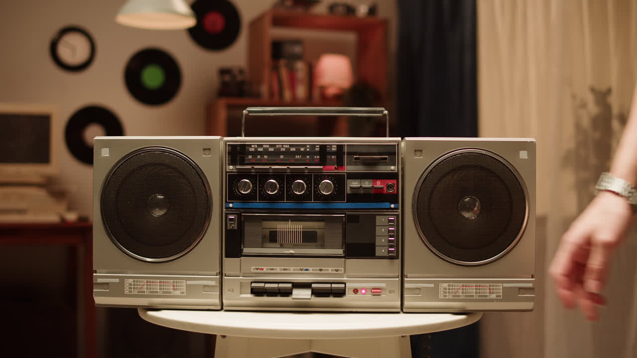 Person Adjusting Boombox in Retro Room