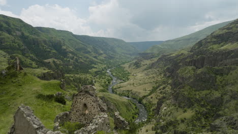 tmogvi fortress ruins on the hilltop with mtkvari river in samtskhe-javakheti, georgia