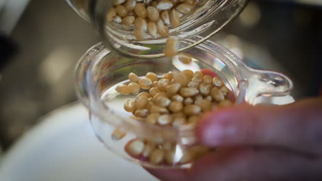 pouring popcorn kernels into a bowl