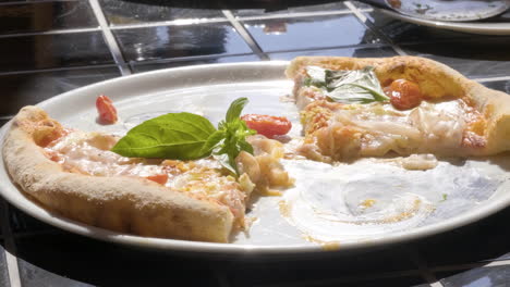 close up of unrecognizable people eating pizza at restaurant