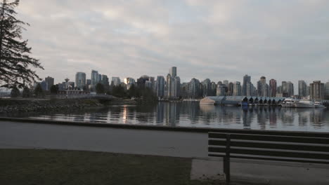 wide dynamic shot of vancouver skyline and boats in morning marina, west end, slowmotion