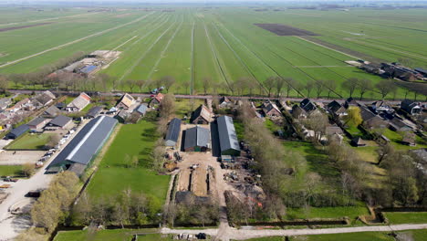 aerial of farms overlooking beautiful green meadows in rural holland