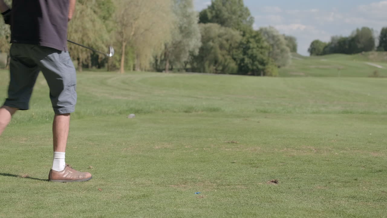 Non-professional golf player running a drive shot
