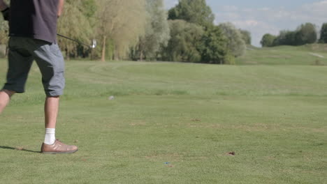 non-professional golf player running a drive shot